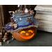 This is a decorative gourd character named Birdie. Her happy face is lit with a battery-operated candle. She is wearing a whimsical hat. 